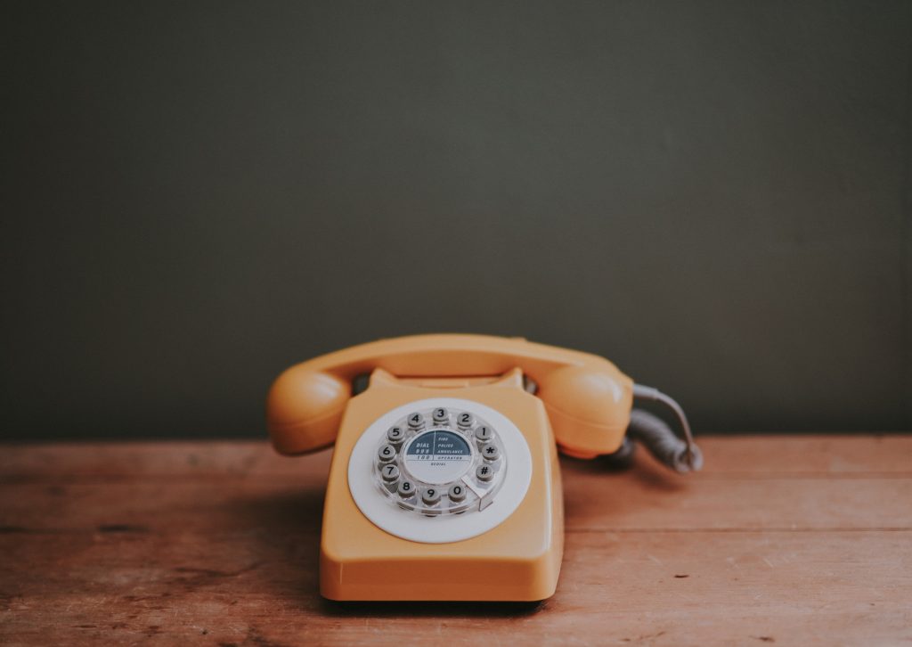 Yellow phone with a green background